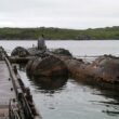 rusted nuclear submarine at dock