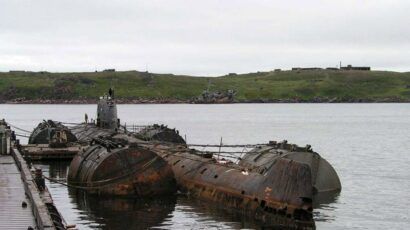 rusted nuclear submarine at dock