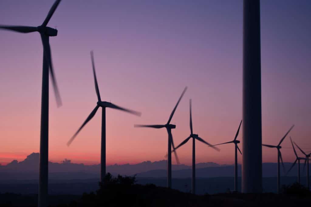 windmills silhouetted against purple background