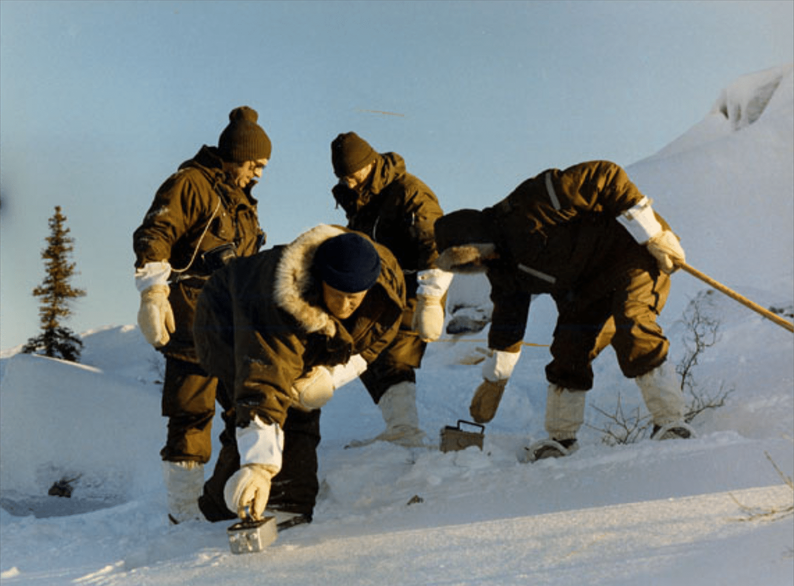 Operation Morning Light. Team members, dressed in specially designed arctic clothing, begin the painstaking process of searching the area with hand-held radiation detectors. (NNSA)