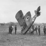 crashed WW1 biplane with spectators