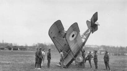 crashed WW1 biplane with spectators