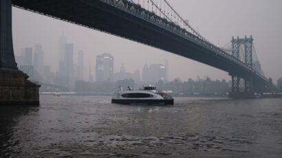 a ferry passes under bridge