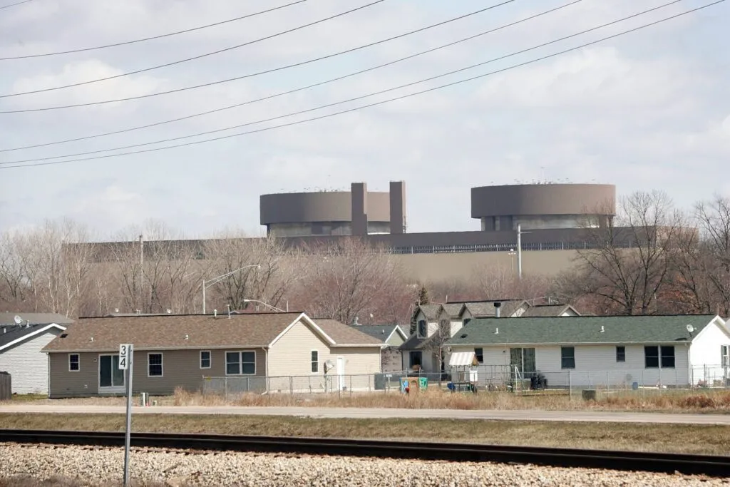 The Braidwood nuclear power plant rises above nearby homes. The state of Illinois and Will County officials sued the owners and operators of the facility in 2006, claiming they failed to report leaks of radioactive tritium from the facility. (Photo by Scott Olson/Getty Images)