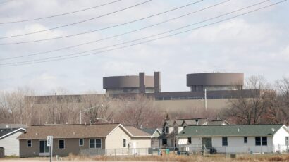 The Braidwood nuclear power plant rises above nearby homes. The state of Illinois and Will County officials sued the owners and operators of the facility in 2006, claiming they failed to report leaks of radioactive tritium from the facility. (Photo by Scott Olson/Getty Images)