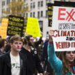 Sign text: Exxon knew about climate change since 1981. Denied it anyway.