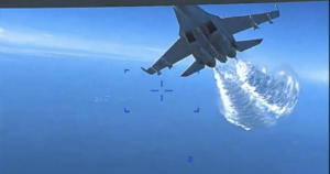 This screen shot from a US Defense Department video clip shows a Russian Su-27 fighter jet flying near an American Reaper drone in March, over the Black Sea near Crimea, spraying what the Defense Department says is jet fuel.