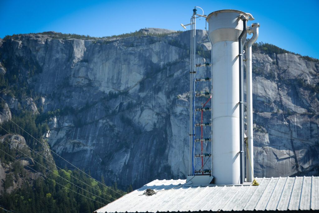 direct air capture plant in front of dramatic rock face mountain