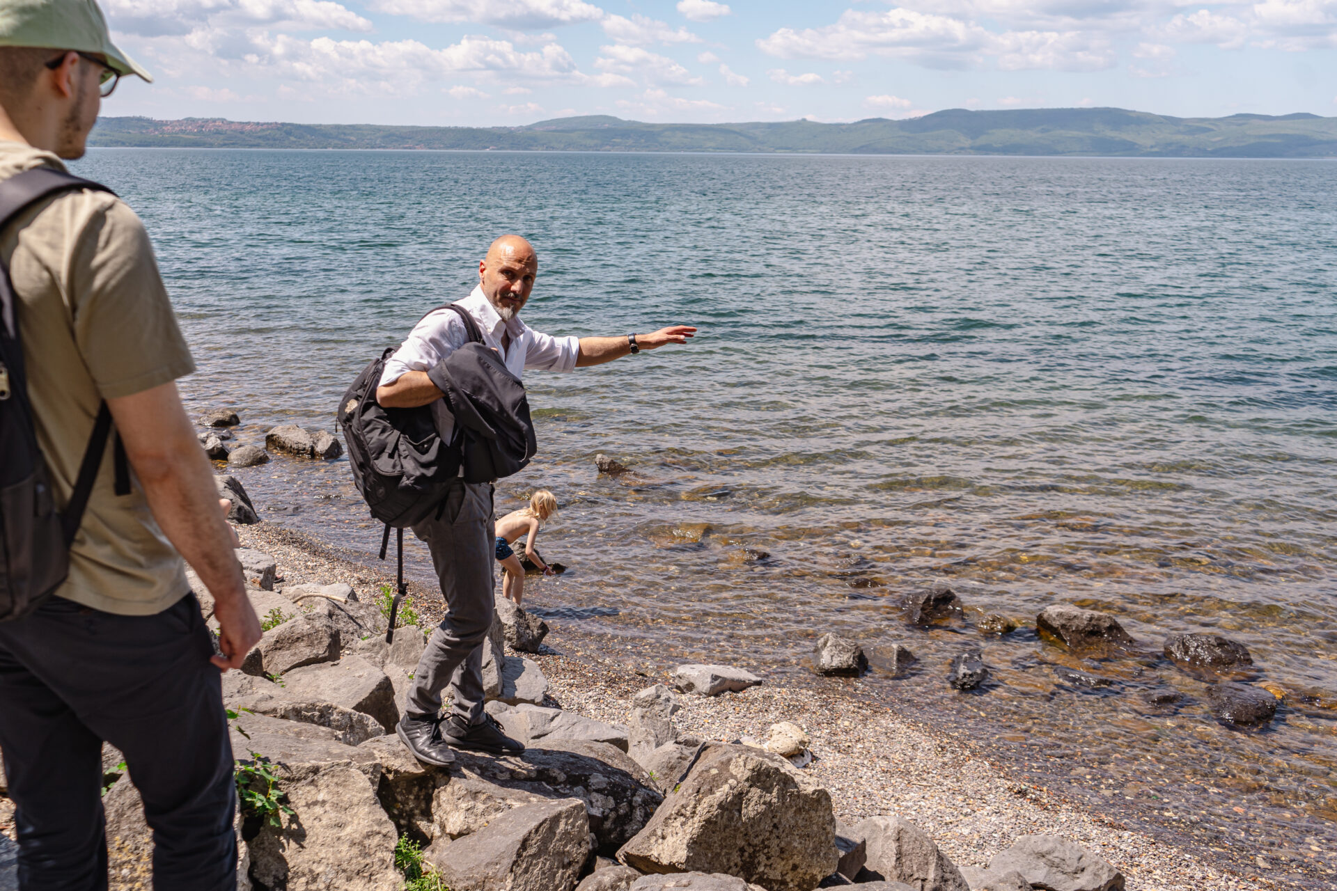 Francesco Falconi points to the rock he used to dive from when he was younger, showing how much the lake has receded. (Federico Ambrosini)