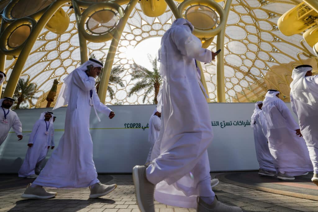Participants arrive at the venue of the COP28 United Nations climate summit in Dubai on November 29. (Photo by GIUSEPPE CACACE/AFP via Getty Images)