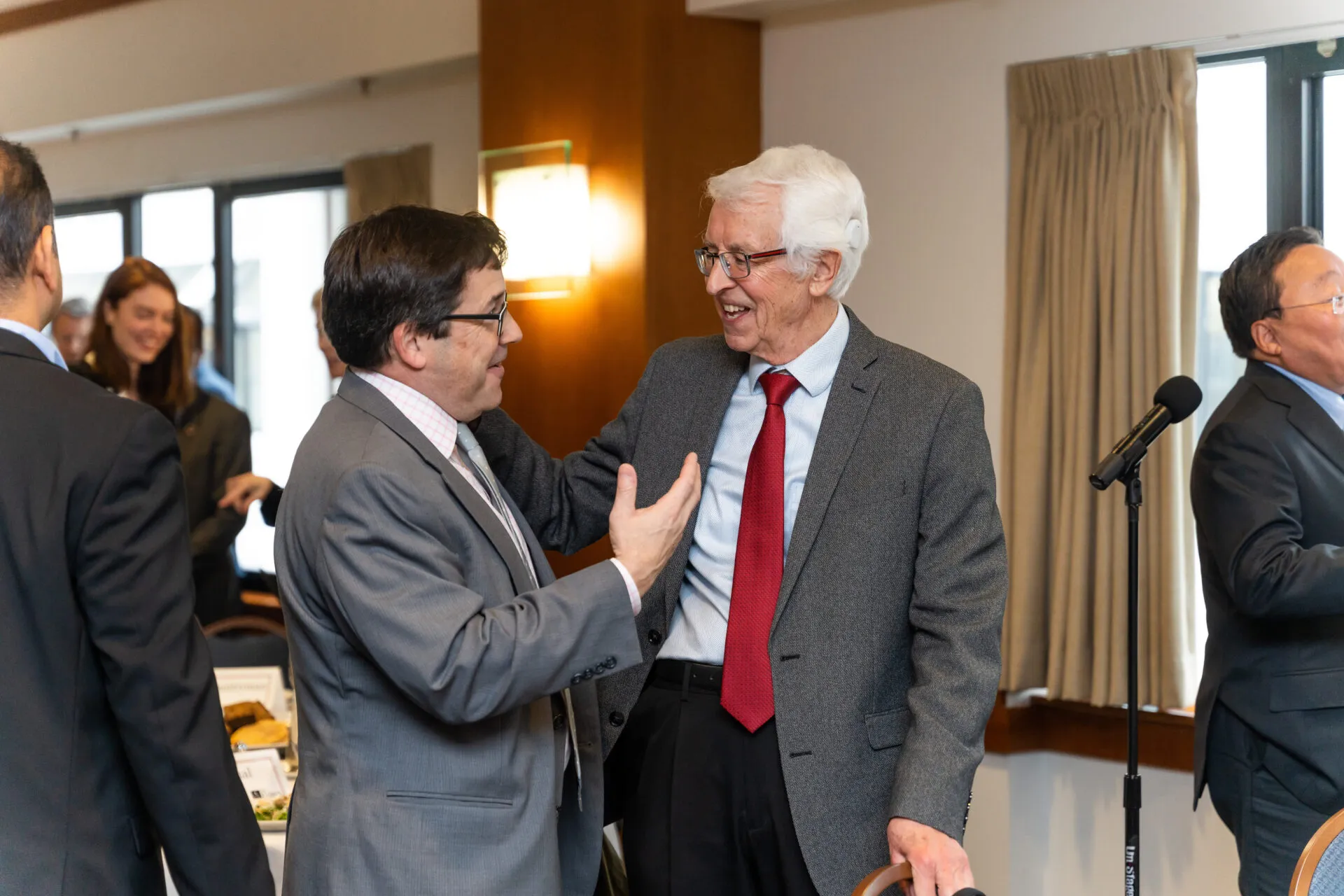 Bulletin Science and Security Board member Jon B. Wolfsthal (left) greets Siegfried Hecker (right), chair of the Bulletin's Board of Sponsors, at a luncheon following the 2023 Doomsday Clock announcement.