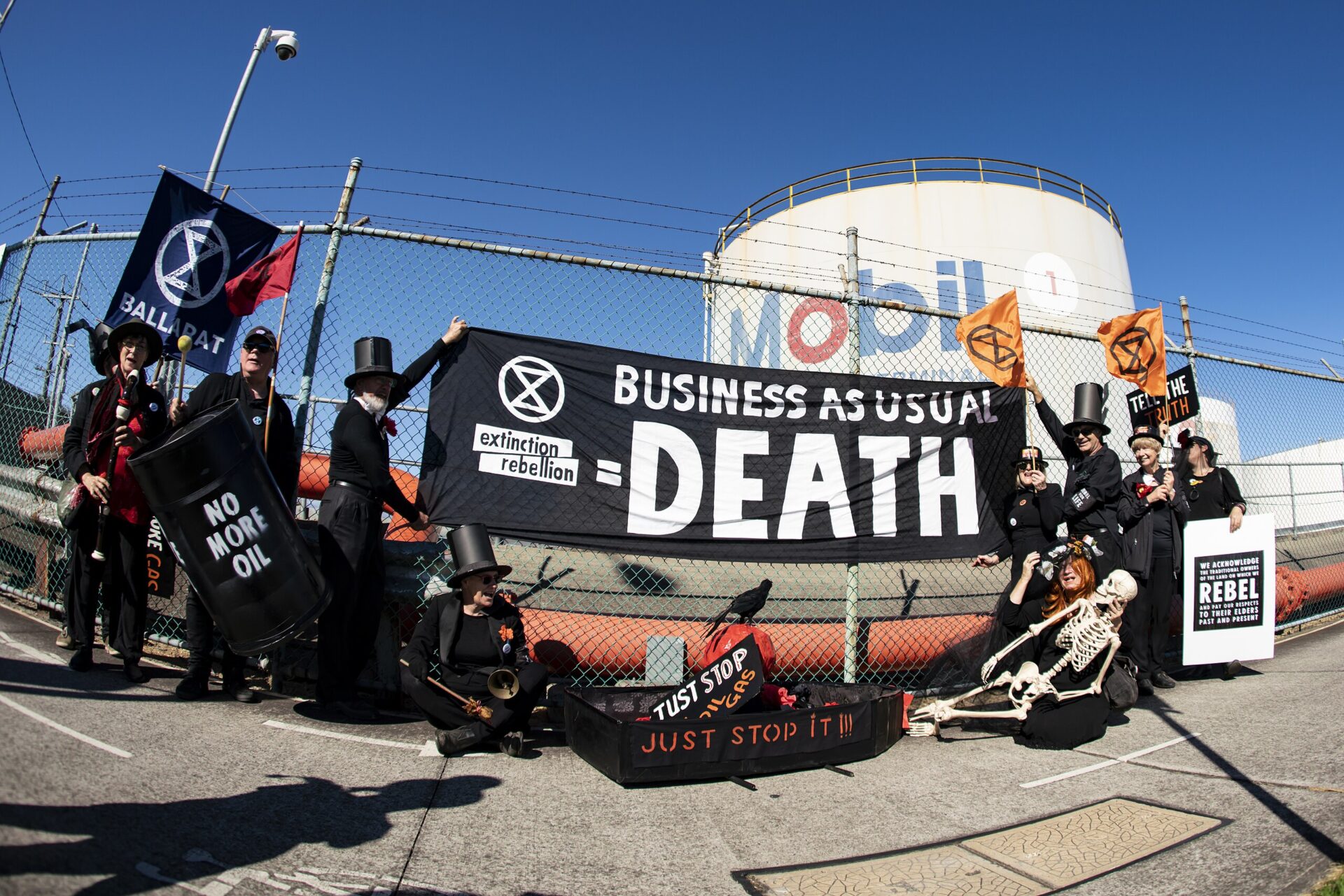protest sign reads business as usual equals death