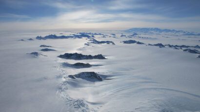 mountain peaks projecting up above a surface of inland ice and snow in West Antarctica
