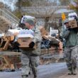 national guard members carry bottle water after hurricane sandy