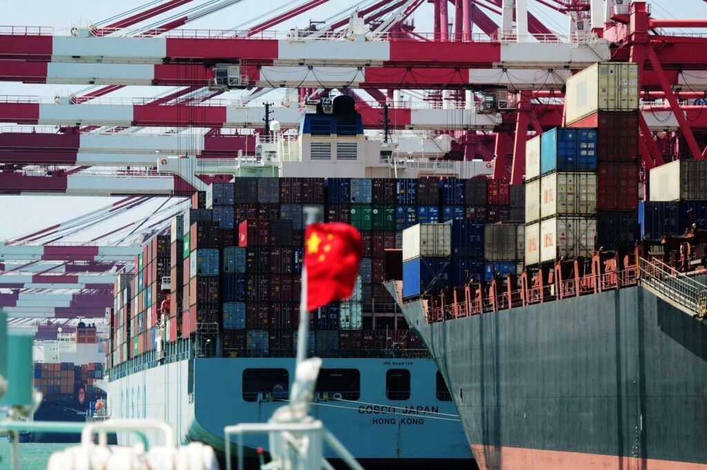 Fully-loaded container ships berth at a dock at the Port of Qingdao in Qingdao city, east Chinas Shandong province. DepositPhotos.com.