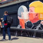 Mural artwork of Russian President Vladimir Putin and U.S. presidential hopeful Donald Trump kissing on the side of a barbecue restaurant in Vilnius, Lithuania in May 2016. Photo by Cebas1