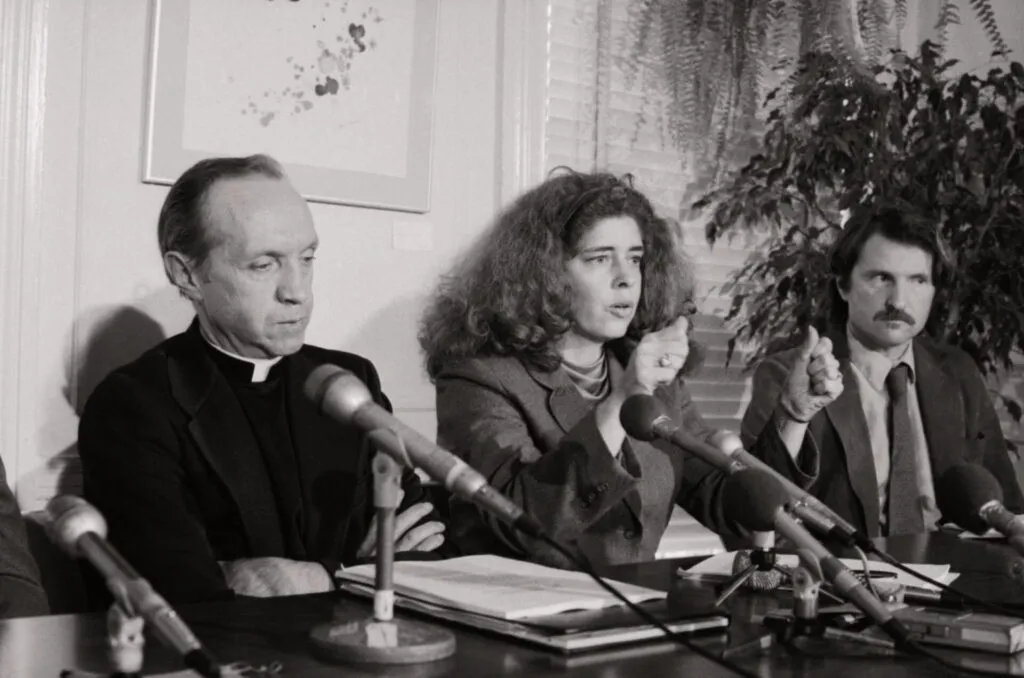 Kitty Tucker, founder of Supporters of Silkwood, describes how Karen Silkwood's car went off the road in 1974 and she was killed, as Father William Davis, investigator for the Silkwood family, listens during a press conference after the Supreme Court upheld the Silkwood family decision.