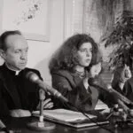 Kitty Tucker, founder of Supporters of Silkwood, describes how Karen Silkwood's car went off the road in 1974 and she was killed, as Father William Davis, investigator for the Silkwood family, listens during a press conference after the Supreme Court upheld the Silkwood family decision.