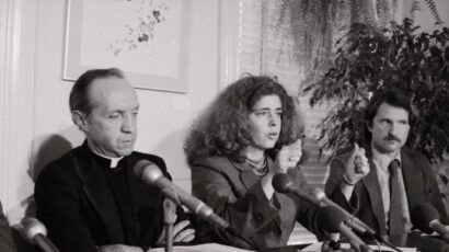 Kitty Tucker, founder of Supporters of Silkwood, describes how Karen Silkwood's car went off the road in 1974 and she was killed, as Father William Davis, investigator for the Silkwood family, listens during a press conference after the Supreme Court upheld the Silkwood family decision.