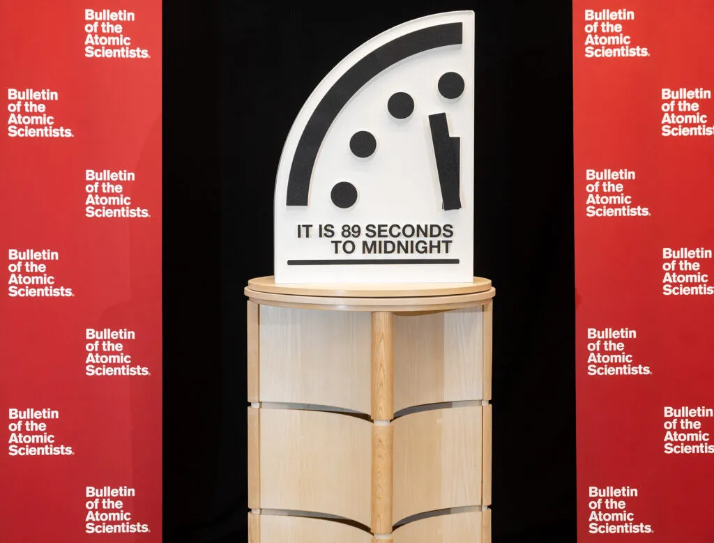 The Doomsday Clock showing "It is 89 seconds to midnight" in between red Bulletin banners. (Photo by Jamie Christiani/Bulletin of the Atomic Scientists)