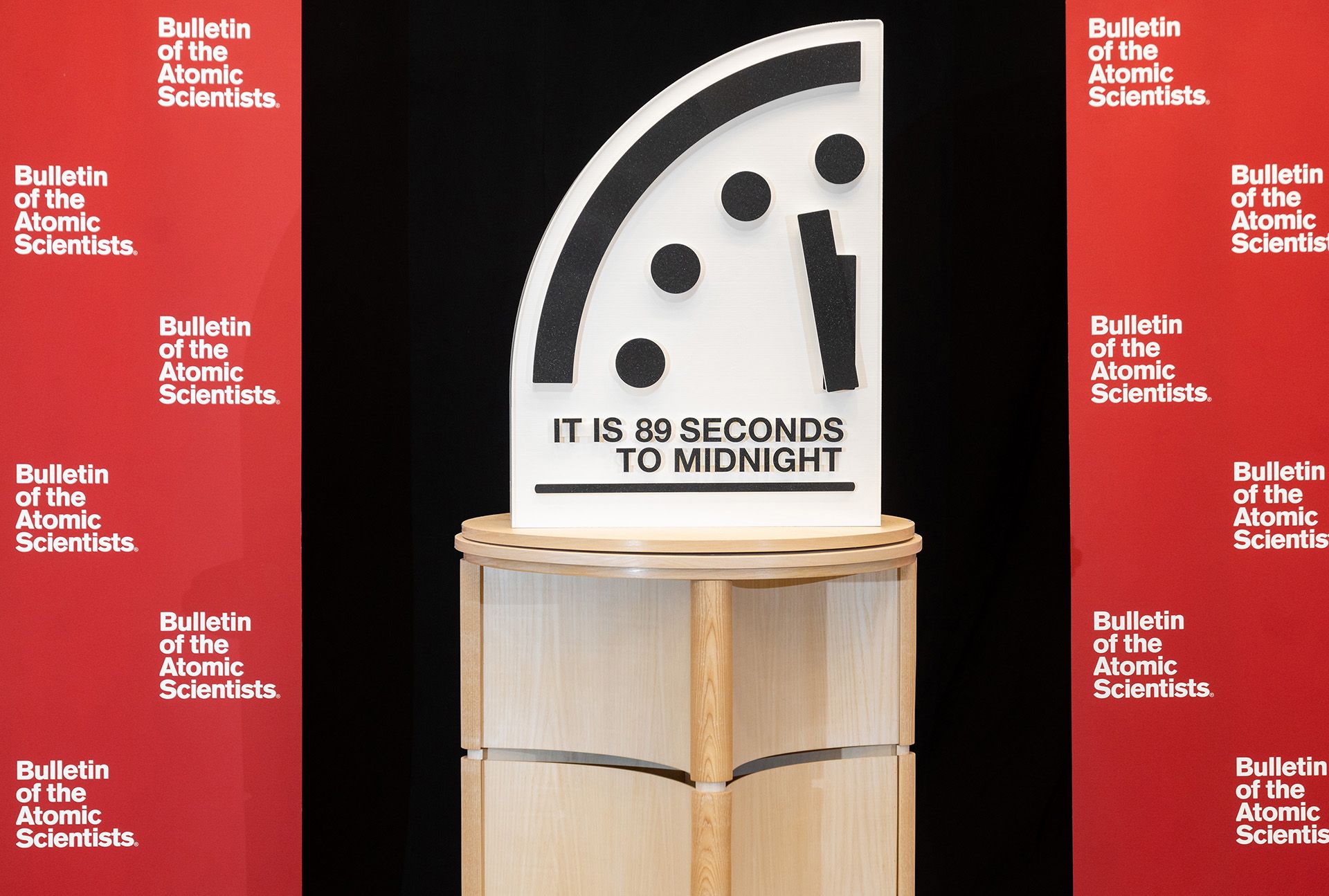 The Doomsday Clock showing "It is 89 seconds to midnight" in between red Bulletin banners. (Photo by Jamie Christiani/Bulletin of the Atomic Scientists)