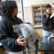 Students test a model wind turbine they constructed.