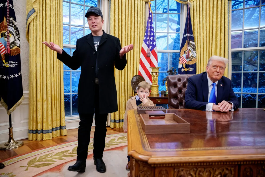 Tesla and SpaceX CEO Elon Musk, accompanied by President Donald Trump and his son X Musk, speaks during an executive order signing in the Oval Office at the White House on February 11. The executive order implements the Department of Government Efficiency's (DOGE) "workforce optimization initiative," which, according to Trump, will encourage agencies to limit hiring and reduce the size of the federal government. (Photo by Andrew Harnik/Getty Images)