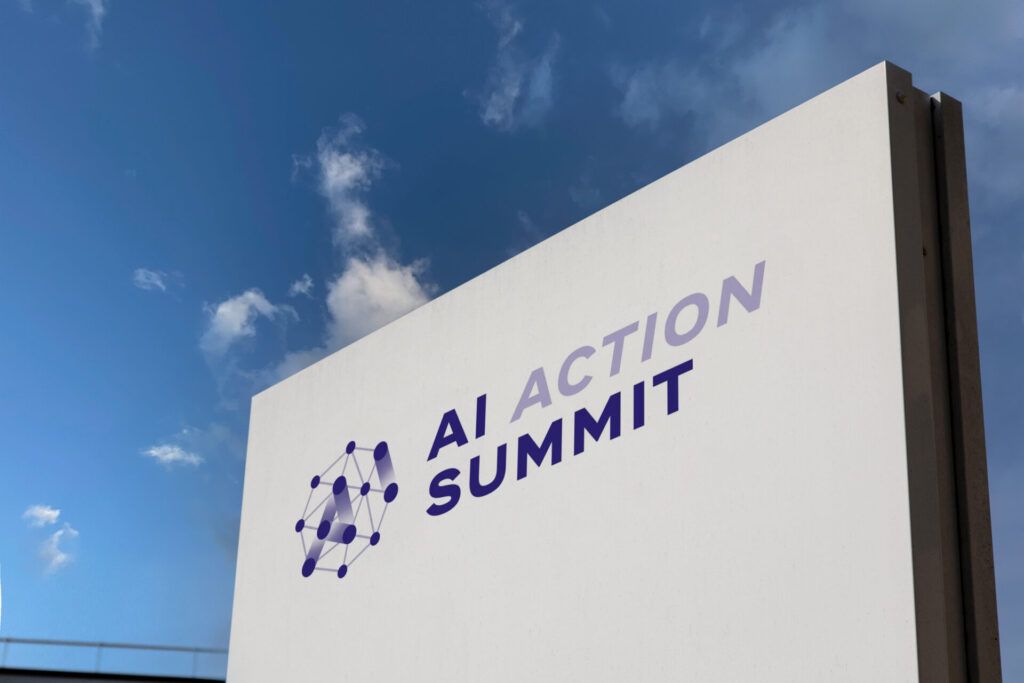 Sign with words "AI Action Summit" against a blue sky