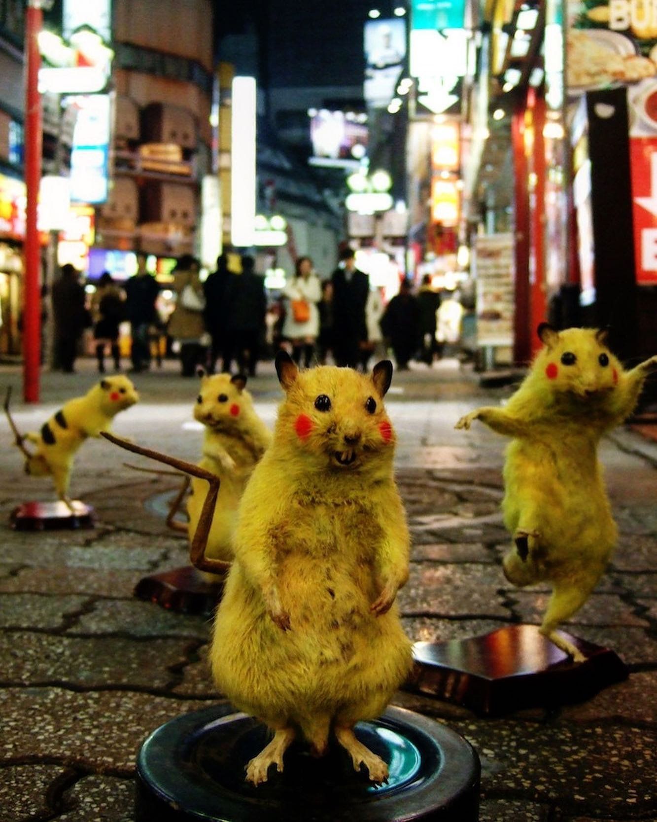 Some of the Chim↑Pom collective’s taxidermized (and Pokemonized) “super rats” on a Tokyo street. <span class="feature_caption_credit">Chim↑Pom from Smappa!Group</span>