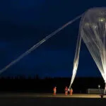 scientists launching balloon to collect atmospheric gases