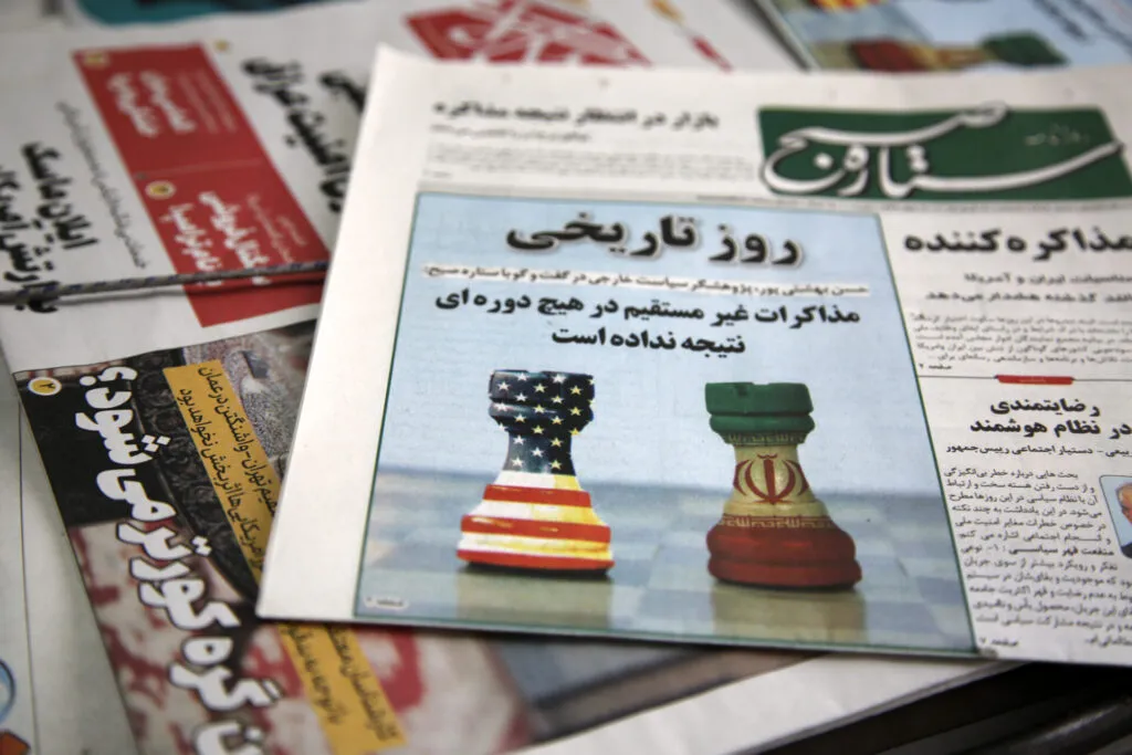 A newspaper featuring the headline story on indirect negotiations between Iran and the United States in Muscat, Oman, is displayed at a newsstand in Tehran, Iran, on April 12. The front pages of major dailies in Tehran prominently featured headlines about the negotiations, highlighting the renewed diplomatic channel amid regional tensions and sanctions-related disputes. (Photo by Fatemeh Bahrami/Anadolu via Getty Images)