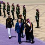 President Trump and Mohammed bin Salman Al Saud walking on a lavender carpet during Trump's Gulf tour in May.