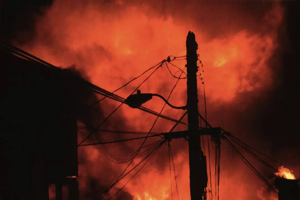 Blazing fire and electricity poles. Image courtesy of UPI Photo Service