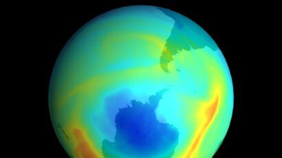 A color-coded satellite image of Earth showing the ozone hole over Antarctica, with blue representing low ozone concentrations and red indicating higher levels.