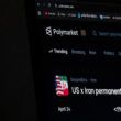 Website interface of the prediction market platform Polymarket showing a geopolitical market regarding the US and Iran is seen displayed on a computer screen.