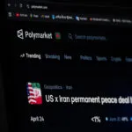 Website interface of the prediction market platform Polymarket showing a geopolitical market regarding the US and Iran is seen displayed on a computer screen.