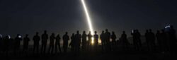 night-time test launch of Minuteman ICBM with silhouettes of crowd