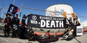 protest sign reads business as usual equals death